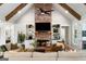 Cozy living room featuring a brick fireplace and built-in shelving with exposed beam ceiling at 2101 Thomas Rd, Canton, GA 30115