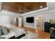 Spacious main bedroom features a wood ceiling, sitting area, TV, and ensuite bathroom access at 2101 Thomas Rd, Canton, GA 30115