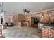 Covered outdoor kitchen with brick accents, stone floor, stainless appliances, and built-in grill at 2101 Thomas Rd, Canton, GA 30115