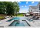 Stunning pool and spa combination with a serene waterfall feature and ample lounge space at 2101 Thomas Rd, Canton, GA 30115
