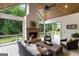Inviting sun room with a brick fireplace, high ceilings, and views of lush greenery at 2101 Thomas Rd, Canton, GA 30115