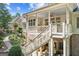Multi-level backyard with lush landscaping, patio, and outdoor seating area at 3088 Hidden Falls Dr, Buford, GA 30519