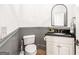 Small bathroom featuring grey wainscoting, a dark countertop, and classic fixtures at 3088 Hidden Falls Dr, Buford, GA 30519