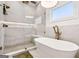 Luxurious bathroom with soaking tub, glass shower featuring seating, and modern fixtures at 3088 Hidden Falls Dr, Buford, GA 30519
