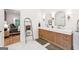 A bright bathroom with double sinks, decorative mirrors and access to a bedroom at 3088 Hidden Falls Dr, Buford, GA 30519