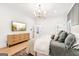 Bright bedroom with a dresser, TV and a view into the bathroom, closet and additional room at 3088 Hidden Falls Dr, Buford, GA 30519