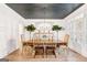 Stylish dining room with gray ceiling, decorative lighting, and wood dining table with chairs at 3088 Hidden Falls Dr, Buford, GA 30519