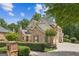 Well-maintained two-story brick home with a circular driveway and manicured landscaping at 3088 Hidden Falls Dr, Buford, GA 30519