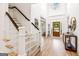 Grand foyer with staircase, high ceilings, hardwood floors, and a decorative front door at 3088 Hidden Falls Dr, Buford, GA 30519
