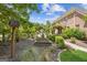Enclosed garden with raised beds, decorative arbor, and lush landscaping at 3088 Hidden Falls Dr, Buford, GA 30519