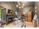 Home office with dark walls, fireplace, built-in shelves, and modern lighting at 3088 Hidden Falls Dr, Buford, GA 30519
