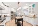 Bright, open kitchen with white cabinetry, stainless appliances, and an island with wood top at 3088 Hidden Falls Dr, Buford, GA 30519