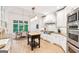 Spacious kitchen boasts white cabinets, stainless steel appliances, and breakfast area at 3088 Hidden Falls Dr, Buford, GA 30519