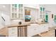 Bright kitchen view features white cabinets and modern stainless steel appliances at 3088 Hidden Falls Dr, Buford, GA 30519