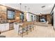 Open-concept kitchenette featuring bar seating, stone accent wall, and view into living area at 3088 Hidden Falls Dr, Buford, GA 30519