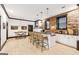 Modern kitchenette featuring stone accent wall, countertop seating, and contemporary lighting at 3088 Hidden Falls Dr, Buford, GA 30519