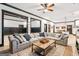 Spacious living room featuring a large sectional sofa, a wooden coffee table, and an open floorplan layout at 3088 Hidden Falls Dr, Buford, GA 30519