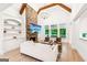 Bright living room featuring a stone fireplace, exposed beams, and elegant chandelier at 3088 Hidden Falls Dr, Buford, GA 30519