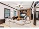 Cozy living room featuring stone accent wall, built-in shelving, large windows, and a comfortable sectional sofa at 3088 Hidden Falls Dr, Buford, GA 30519