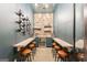 Charming wine cellar with stone accents, a built-in wine fridge, barstool seating, and a hanging wine rack at 3088 Hidden Falls Dr, Buford, GA 30519