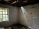 Basement view with window and white walls, requiring renovation at 372 Nalley Dr, Stone Mountain, GA 30087