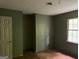 Bedroom features a window and a closet, with green walls at 372 Nalley Dr, Stone Mountain, GA 30087