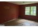 A bedroom with a large window providing natural light and hardwood floors at 372 Nalley Dr, Stone Mountain, GA 30087