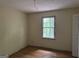 Bedroom with hardwood floors and a window letting in natural light at 372 Nalley Dr, Stone Mountain, GA 30087