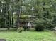 Exterior of a charming home nestled within a lush, wooded landscape, offering privacy and natural beauty at 372 Nalley Dr, Stone Mountain, GA 30087