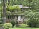 Two-story home exterior with mature trees, dark shutters, and a white front door at 372 Nalley Dr, Stone Mountain, GA 30087