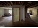 Living room with exposed studs, hardwood flooring, and a view into an adjacent room at 372 Nalley Dr, Stone Mountain, GA 30087