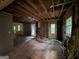 Open-concept living room with exposed ceiling, hardwood flooring and natural light at 372 Nalley Dr, Stone Mountain, GA 30087