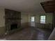 Cozy living room with a stone fireplace and ample natural light from the door and window at 372 Nalley Dr, Stone Mountain, GA 30087