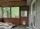 Enclosed porch with door that leads to deck and view of wooded area at 372 Nalley Dr, Stone Mountain, GA 30087