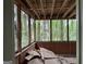 Enclosed porch needing repair with views of surrounding trees at 372 Nalley Dr, Stone Mountain, GA 30087