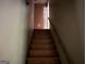 A staircase with wood steps and white walls leading to the upper level of the home at 372 Nalley Dr, Stone Mountain, GA 30087