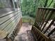 Wooden stairs leading to a deck surrounded by trees at 372 Nalley Dr, Stone Mountain, GA 30087