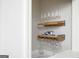 Elegant wet bar features a wine fridge, decorative shelves, and stone countertop at 2689 Spring Rock Ne Ct, Roswell, GA 30075