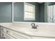 Bathroom vanity featuring a white sink, chrome faucet, and large mirror at 2689 Spring Rock Ne Ct, Roswell, GA 30075