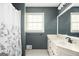Bathroom with white vanity and floral shower curtain at 2689 Spring Rock Ne Ct, Roswell, GA 30075