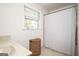 Bright bathroom featuring a window, shower with white curtain, and woven basket at 2689 Spring Rock Ne Ct, Roswell, GA 30075