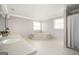 Bright bathroom showcasing a soaking tub on a platform, a double vanity, and tiled floors at 2689 Spring Rock Ne Ct, Roswell, GA 30075
