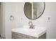 Modern bathroom with white countertop, round mirror and updated faucet at 2689 Spring Rock Ne Ct, Roswell, GA 30075