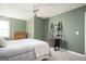Bedroom featuring green walls, light carpet and a ceiling fan at 2689 Spring Rock Ne Ct, Roswell, GA 30075