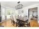Elegant dining room with hardwood floors, modern lighting, and multiple windows at 2689 Spring Rock Ne Ct, Roswell, GA 30075