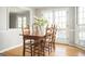 Cozy dining room features wooden table and chairs, and double doors to the outside at 2689 Spring Rock Ne Ct, Roswell, GA 30075