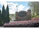 East Spring Lake community entrance featuring a stone sign and vibrant greenery at 2689 Spring Rock Ne Ct, Roswell, GA 30075