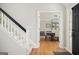 Bright entryway featuring hardwood floors, a black front door, and a view into the dining room at 2689 Spring Rock Ne Ct, Roswell, GA 30075