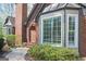 A close-up of the brick exterior, showcasing the bay window and well-maintained landscaping at 2689 Spring Rock Ne Ct, Roswell, GA 30075