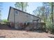 Rear exterior with a multi-level deck, gray siding, and mature landscaping at 2689 Spring Rock Ne Ct, Roswell, GA 30075